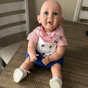 Adorable Baby Doll with Striped Shirt and Blue Shorts